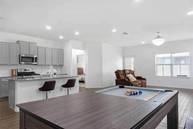 Game room with dark wood-style floors, a sink, baseboards, visible vents, and recessed lighting | Image 11