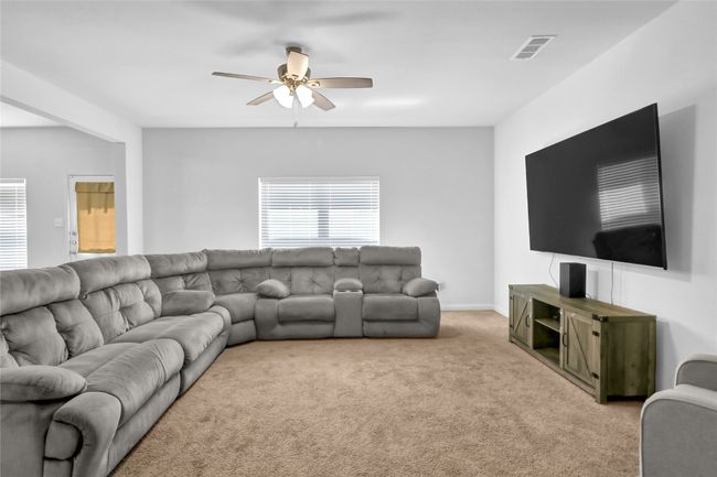 Living room featuring light carpet, ceiling fan, and visible vents | Image 6
