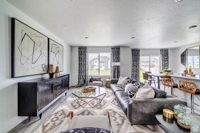 Living room featuring light hardwood / wood-style flooring and a healthy amount of sunlight | Image 3