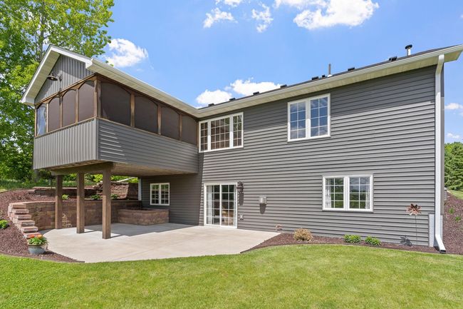 Another large patio area out back that's partially covered | Image 11