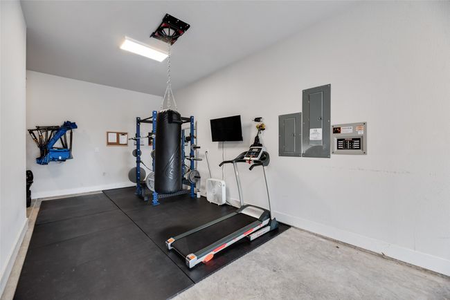 Exercise area with electric panel and baseboards | Image 35