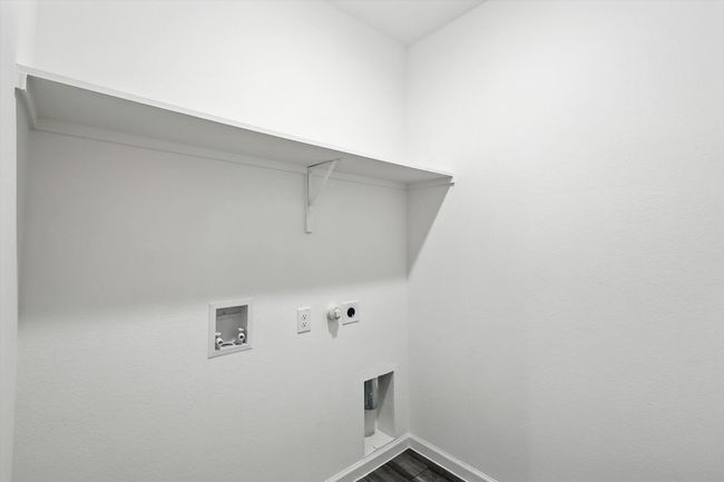 Laundry area with hookup for a washing machine, hookup for an electric dryer, hookup for a gas dryer, and dark wood finished floors | Image 15
