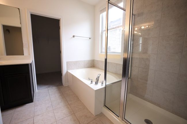 Soak off the day;s stress in the relaxing garden/soaking tub under a window and enjoy a separate shower. | Image 13
