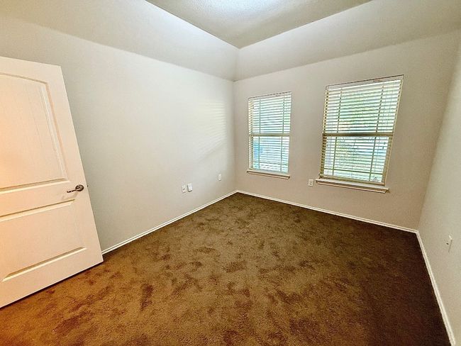 Unfurnished room with dark carpet and vaulted ceiling | Image 14
