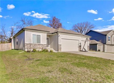 View of front of house featuring a garage and a front lawn | Image 1