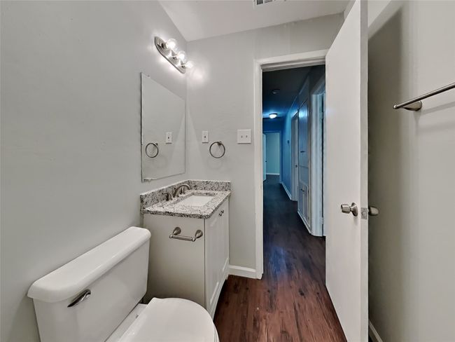 Half bath with vanity and wood finished floors | Image 13
