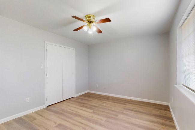 Unfurnished room with ceiling fan, baseboards, and light wood-type flooring | Image 32