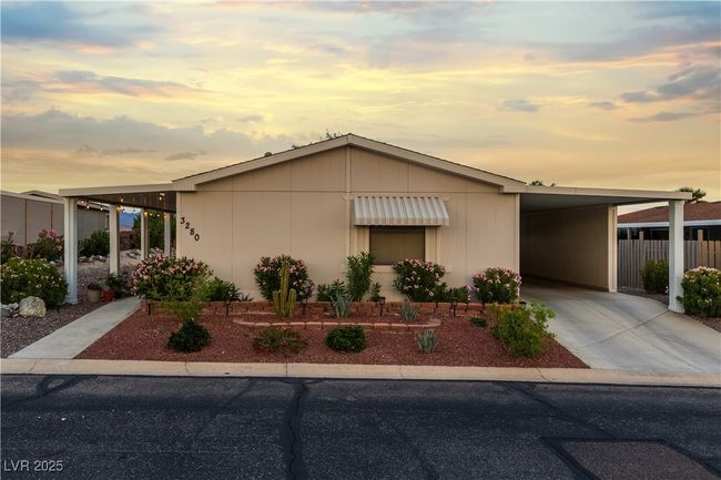 View of front facade with an attached carport, driveway, and fence | Image 20
