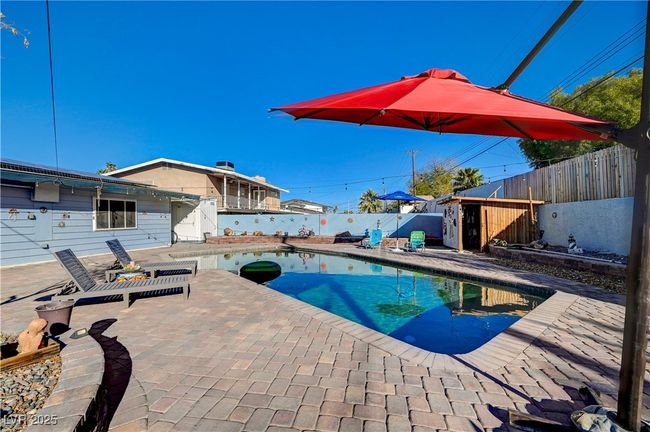 View of pool with a fenced backyard and a patio | Image 29