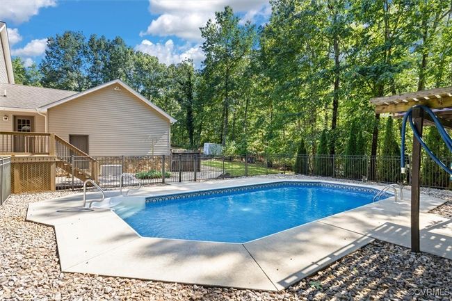 View of pool with a wooden deck and a patio | Image 19