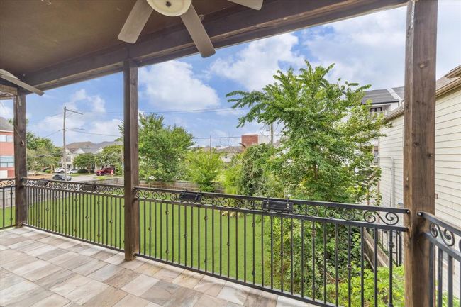 This photo showcases a spacious balcony located off the kitchen/dining room on the 2nd floor. Perfect for outdoor relaxation and entertaining. | Image 25
