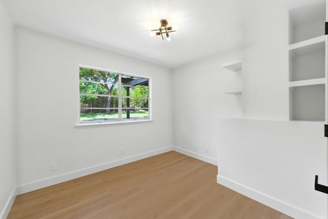 Empty room featuring light wood-style flooring and baseboards | Image 15