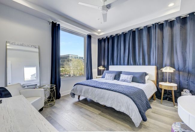 Bedroom featuring wood finished floors, multiple windows, ceiling fan, and recessed lighting | Image 14