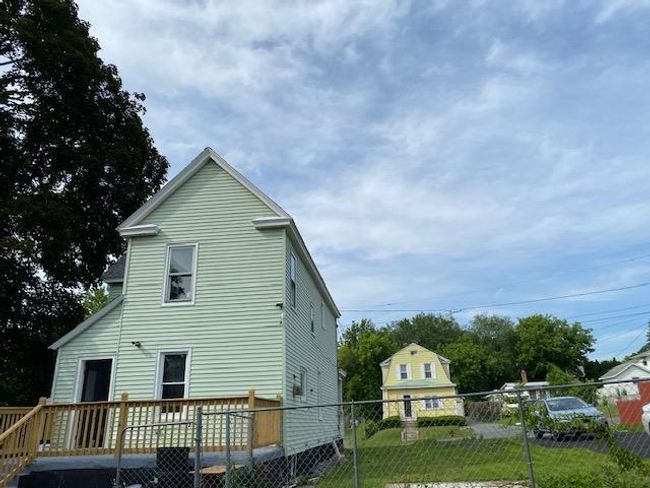 Rear view of house featuring a wooden deck | Image 5