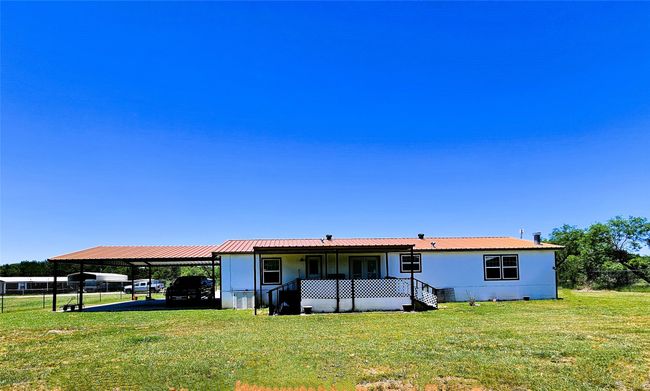 Back of house featuring a carport and metal roof | Image 23