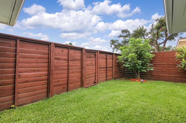 The backyard has plenty of green space for the kids and pets to play. | Image 28