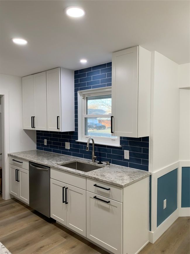 Kitchen with dishwasher, light wood-type flooring, decorative backsplash, white cabinets, and recessed lighting | Image 6