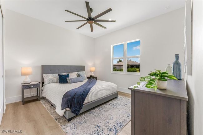 Bedroom featuring light wood-style flooring and ceiling fan | Image 18