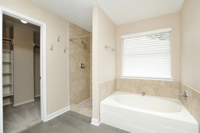 Primary ensuite features huge walk-in closet, stand-alone shower and large soaker tub. | Image 26