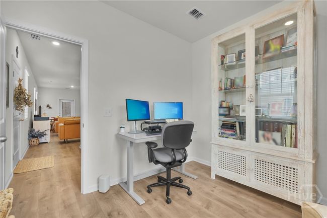 Office is tuck away from the living room. | Image 48