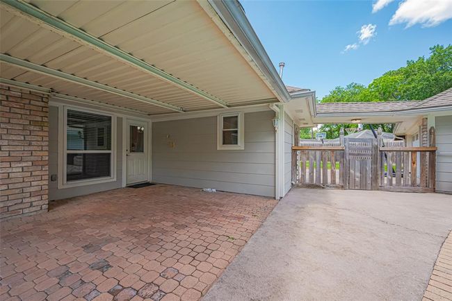Covered patio and gate to the backyard | Image 45