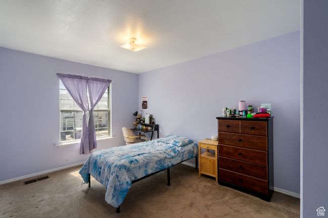 Carpeted bedroom featuring visible vents and baseboards | Image 17