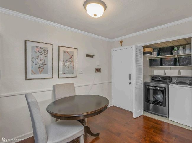Dining room with washing machine and clothes dryer, ornamental molding, and dark wood finished floors | Image 10