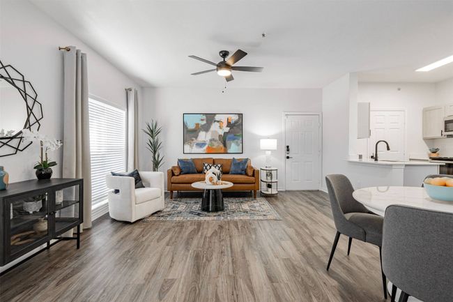 Living room with ceiling fan, sink, and wood-type flooring | Image 10