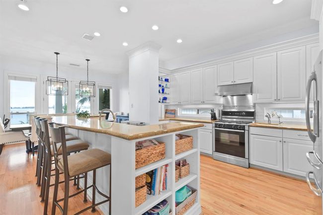 Elegant granite breakfast bar with ample storage and seating for guests. | Image 18