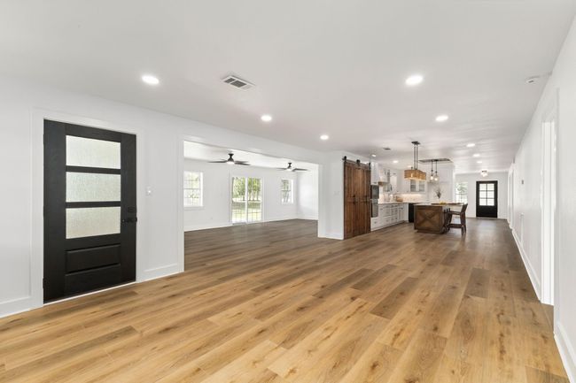 Spacious open-concept living and dining area with abundant natural light. | Image 18