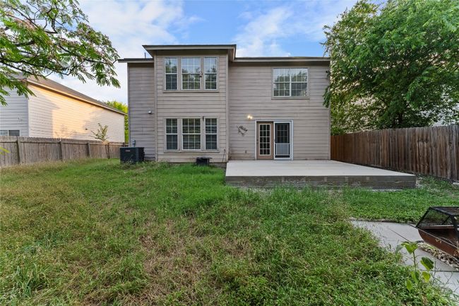 Rear view of house with a fenced backyard, a patio, and central AC unit | Image 33