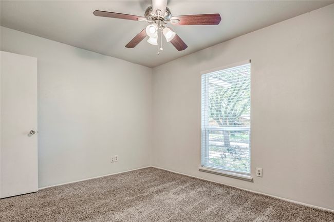 Empty room featuring healthy amount of natural light, carpet flooring, and a ceiling fan | Image 33