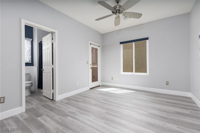 Unfurnished bedroom featuring connected bathroom, baseboards, a ceiling fan, and light wood-type flooring | Image 14