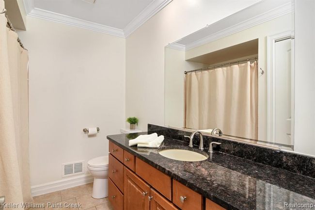 Full bath features an expansive granite vanity with tons of storage options. | Image 11