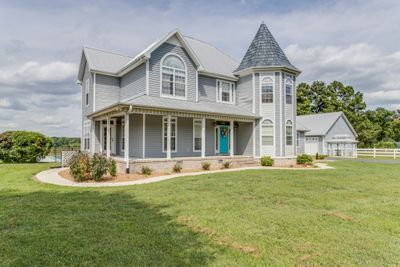 This stunning estate features a main house, spacious pool house, 4-car detached garage, barn & 5 acres! | Image 1