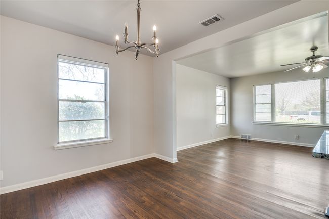 Spare room with dark wood-style flooring, baseboards, and visible vents | Image 9