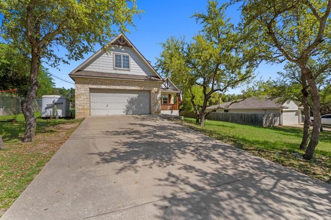 View of yard featuring an attached garage and fence | Image 4