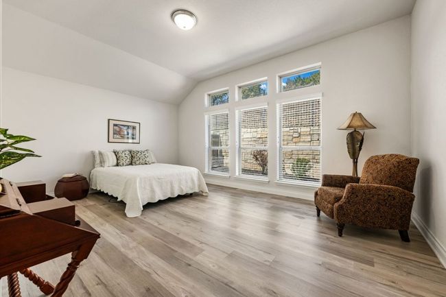 Bedroom with light wood-style flooring, baseboards, and vaulted ceiling | Image 18
