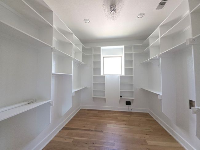 Walk in closet featuring wood finished floors | Image 18