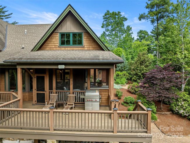 Main level deck with partially covered area for grilling/relaxing, open deck area and stairs down to side yard. | Image 41