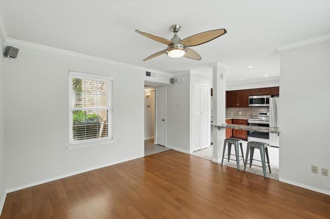 Unfurnished living room featuring ceiling fan, wood finished floors, ornamental molding, baseboards, and recessed lighting | Image 8