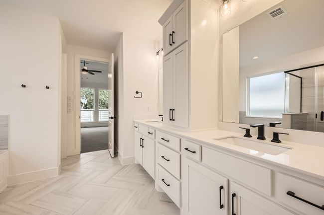 Full bathroom featuring double vanity, baseboards, ceiling fan, a shower with door, and recessed lighting | Image 19