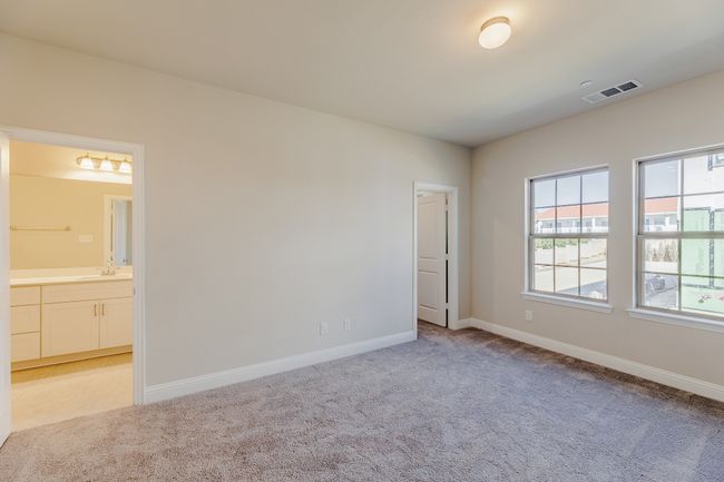 Unfurnished bedroom with light colored carpet and ensuite bath | Image 16