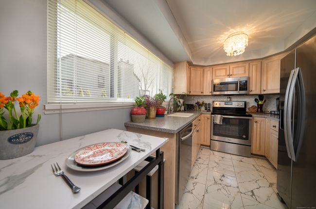 Kitchen has solid wood cabinets, Corian counters, stainless appliances | Image 8