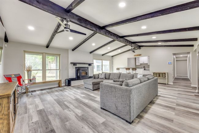 Living room featuring healthy amount of natural light, recessed lighting, light wood-style floors, and a fireplace | Image 10