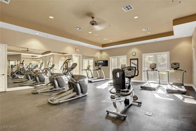 Gym featuring a raised ceiling, recessed lighting, baseboards, and ceiling fan | Image 77