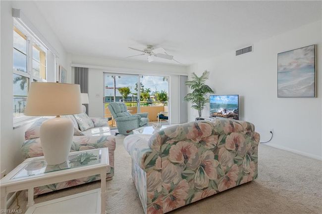 Living room with ceiling fan and carpet floors | Image 6