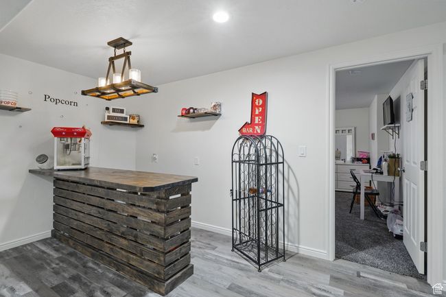 Bar featuring baseboards and wood finished floors | Image 31