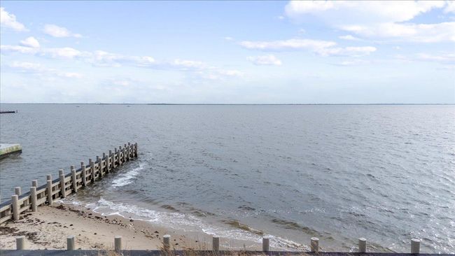 Dock area with a water view and a view of the beach | Image 10