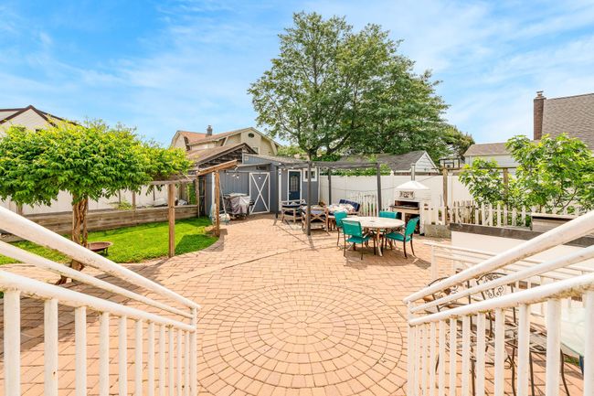 Fenced backyard with outdoor dining space and a patio area | Image 8